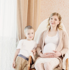pregnant mother with child in home interior