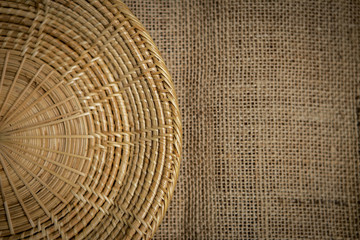 Vintage style background of rattan tray on hessian background