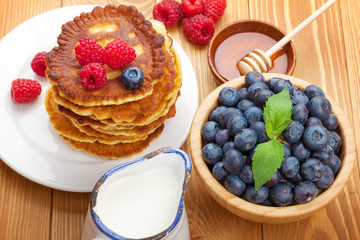 Pancakes with raspberry, blueberry, milk and honey syrup