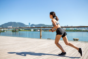 Woman running at seaside walk