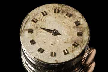 Mechanism of old clock with shabby clock face.