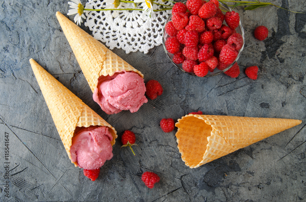 Fototapete raspberry ice cream with ice cream cones on stone table. top view.