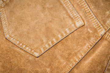 Texture of brown jeans with seam, background
