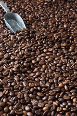 Coffee beans and silver spoon background

