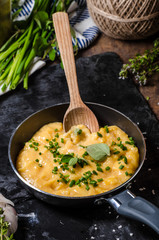 Scrambled eggs in a frying pan