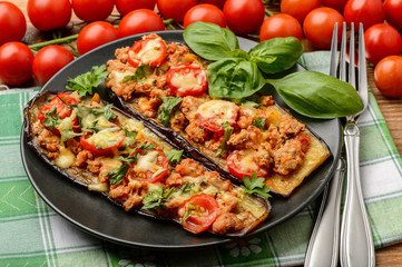 Delicious appetizer -grilled eggplants baked with minced meat, tomatoes and cheese.