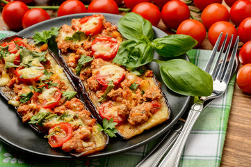 Delicious appetizer -grilled eggplants baked with minced meat, tomatoes and cheese.