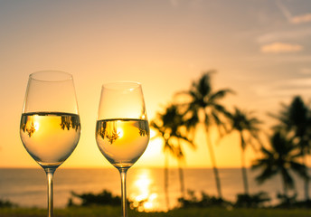 Vacation and holiday concept. Enjoy a glass of wine and beautiful sunset view. 