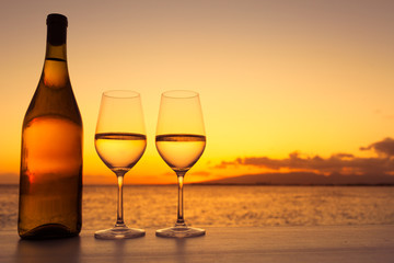 Pair of wine glasses against a beautiful sunset. 