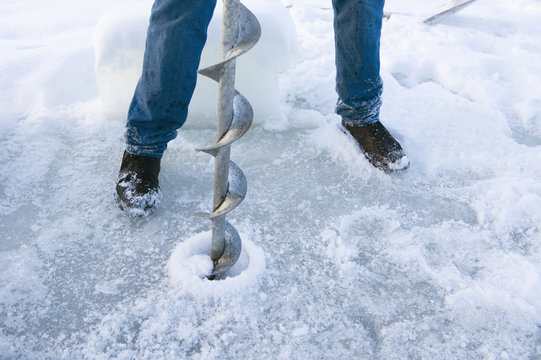 Man drilling ice