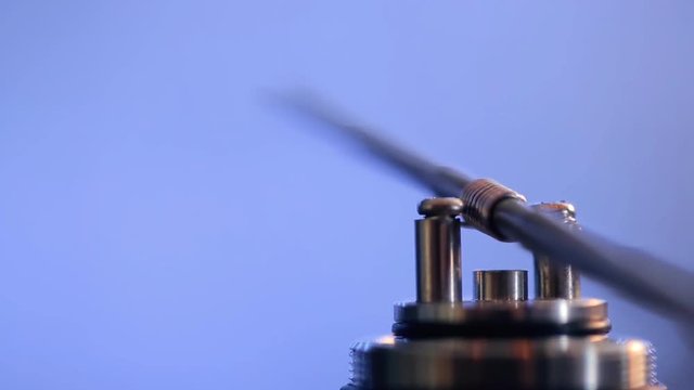 Replacement spiral microcoil at base of clearomizer with coil jig closeup.