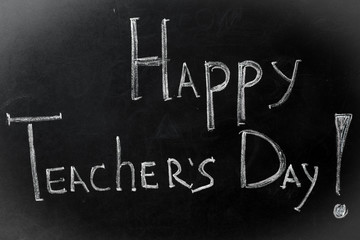 Obraz premium chalk inscription, happy teacher's day on black Board