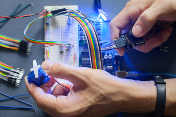 Robotics development closeup., electronic invention. Engineer, programmer, inventor hands with...