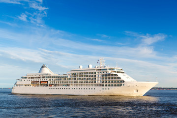 Fototapeta na wymiar White cruise ship passes barrage gates Gulf of Finland