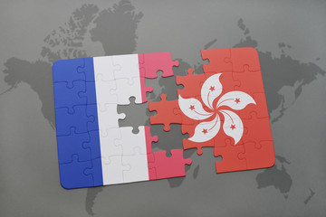 puzzle with the national flag of france and hong kong on a world map background.
