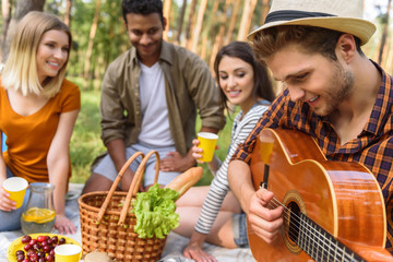 Happy young people making picnic