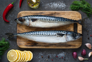 Raw mackerel on a dark background.