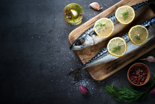 Raw mackerel on a dark background.