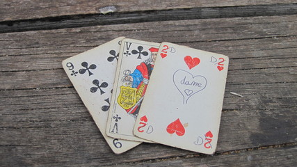 Old playing cards on wooden background