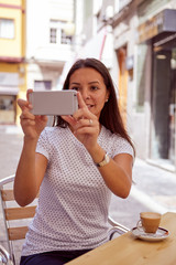 Happily smiling pretty girl taking pictures