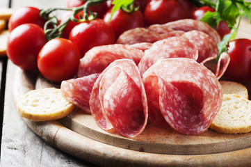 Fresh salami with tomato and bread