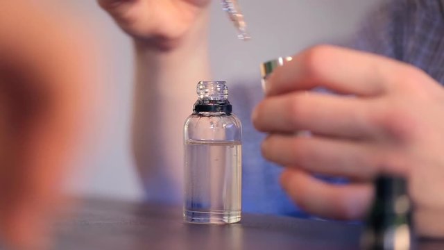 Mixing liquid for vaping using pipette closeup.
