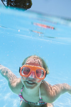 Italy, Sardinia, Alghero, Teenage girl (14-15) diving in swimming pool