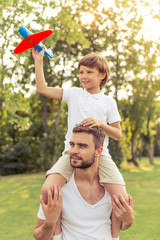 Obraz premium Dad and son resting outdoors