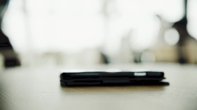 Smartpone put on the wooden table with copy space in the coffee shop HD