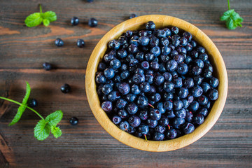 blueberries in a bowl on wooden table