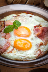 Fried eggs with bacon.
