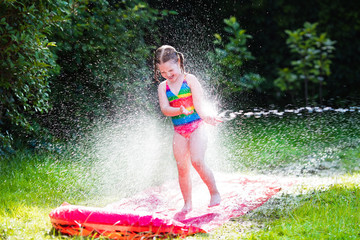 Child playing with garden water slide