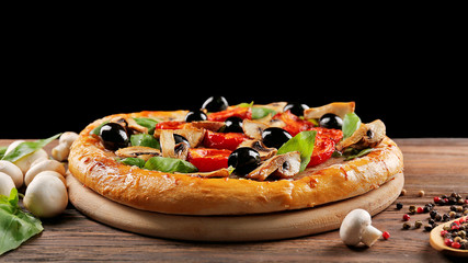 Delicious tasty pizza with ingredients on wooden table