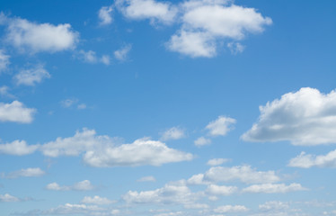 Naklejka na ściany i meble White clouds flying against clear blue sky.