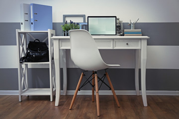 Stylish workplace with laptop at home