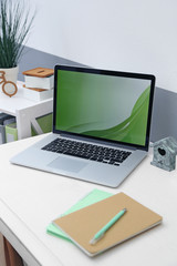 Stylish workplace with laptop at home, closeup