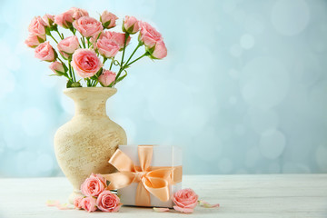 Mother Day concept. Roses with gift box on bokeh background