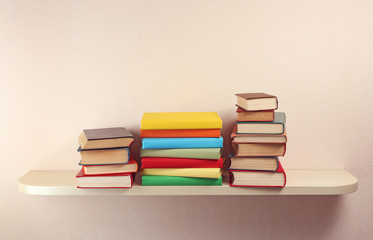 Many books on wooden shelf