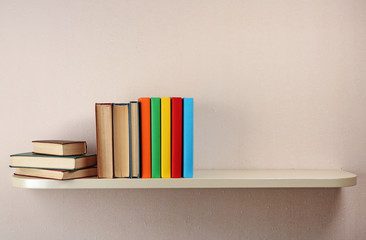 Many books on wooden shelf