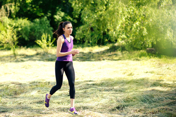Attractive running young woman outdoor. Workout in the park, forest, nature. Sport