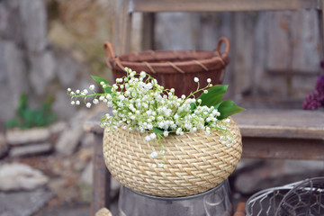Fototapeta na wymiar May-lily in wooden basket