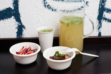 Vegetarian fastfood course with a jag of lemonade on the table