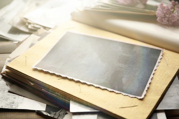 Vintage photos with camera on wooden background