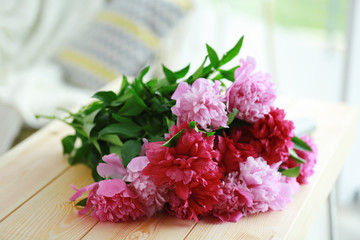 Beautiful peony bouquet on wooden table
