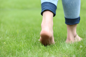 Woman legs on green grass