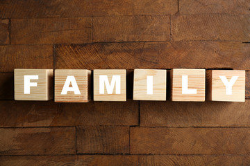 Word FAMILY on wooden background