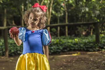 Young Snow White looking to an apple