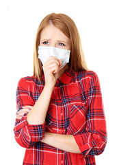Red-haired girl with a medical mask on a white background