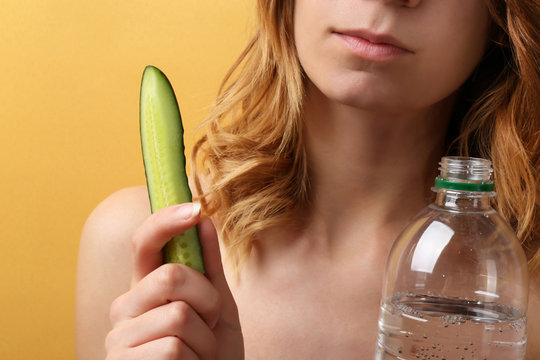 Woman on diet with water and cucumber
