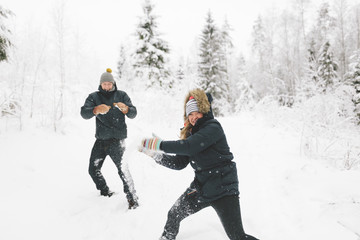Finland, Jyvaskyla, Saakoski, Young couple having snowball fight
